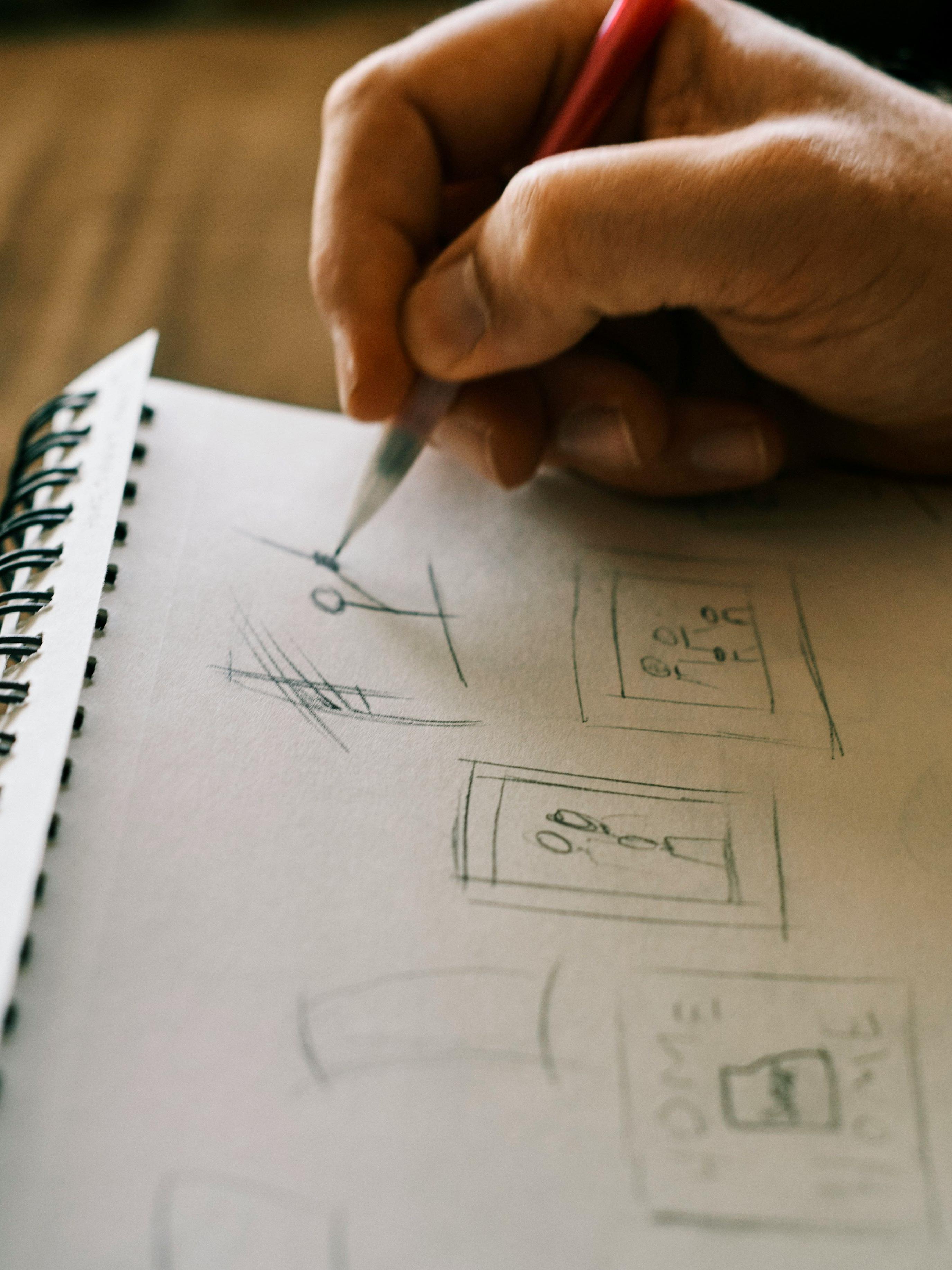 Person sketching on notebook