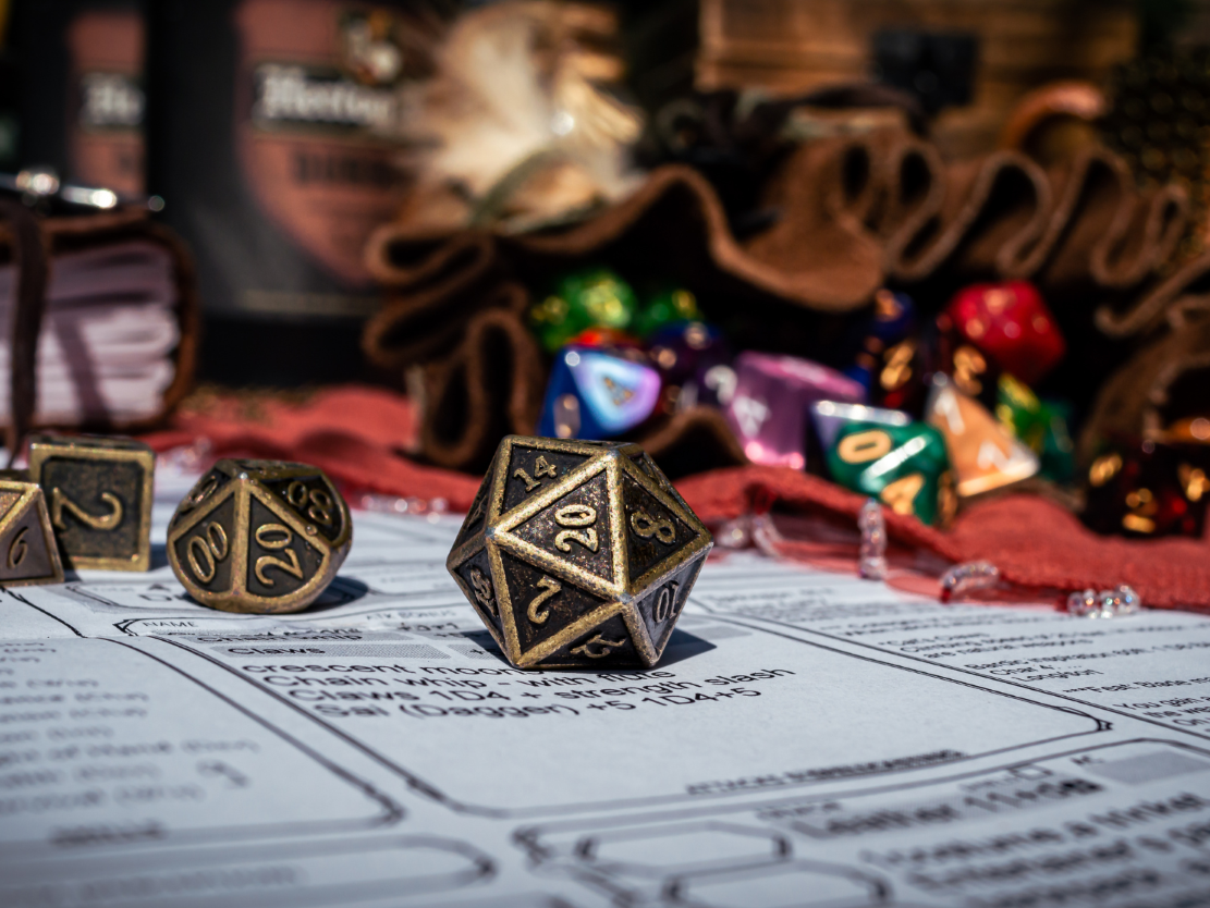 Tabletop dice on a character creation sheet