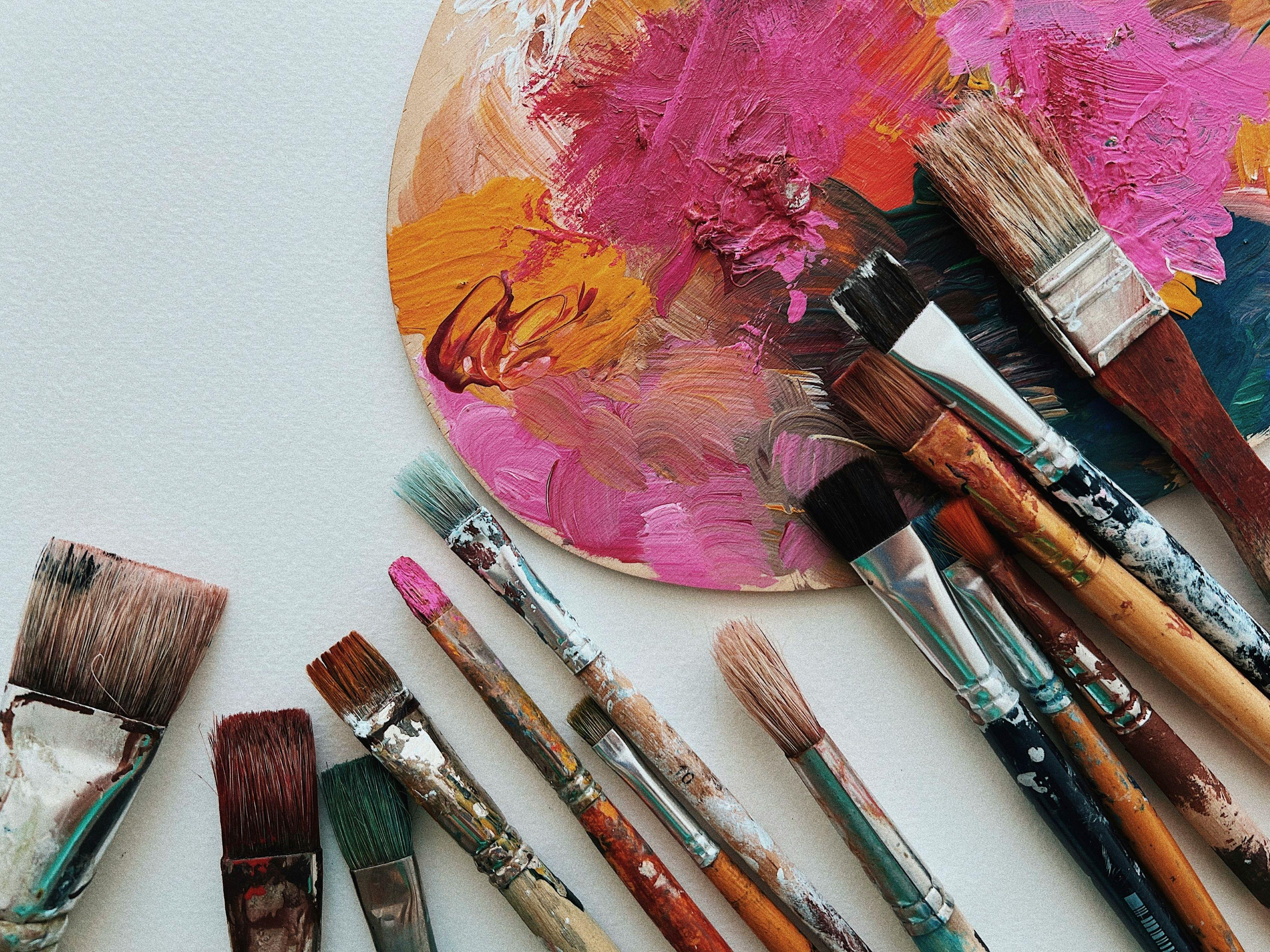 used paintbrushes and a paint palette 